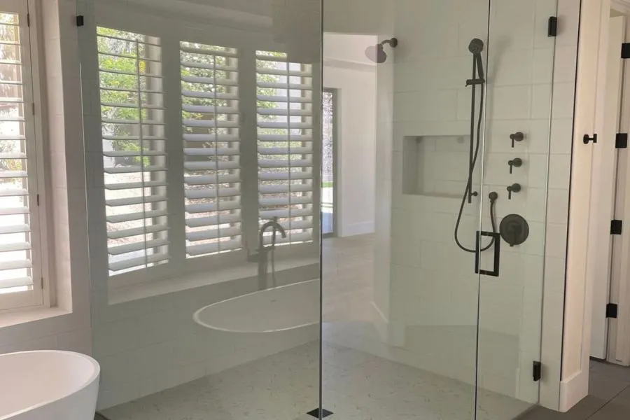 The image captures a a frameless glass shower door, demonstrating our precision in handling shower doors.